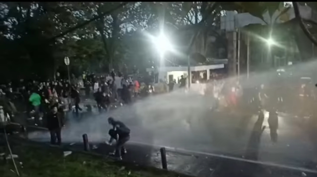 ‎Aparat Kepolisian saat memukul mundur demonstran dengan watercanon dan gas air mata di depan gedung DPRD Sulut, Senin (1/9/2025)