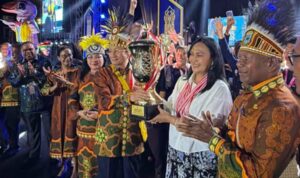 Ketua Umum LPPD Provinsi Sulawesi Utara, Anik Yulius Selvanus saat menerima trophy jauara umum piala presiden. (dok.istimewa)