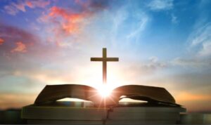 Christian daily devotion concept bible open with cross and morning light