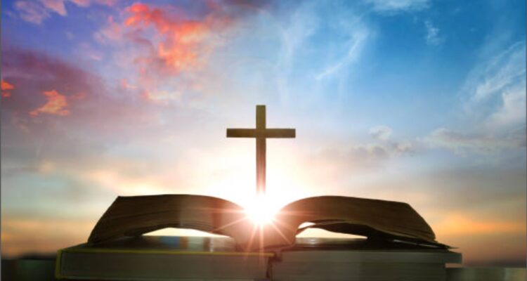 Christian daily devotion concept bible open with cross and morning light