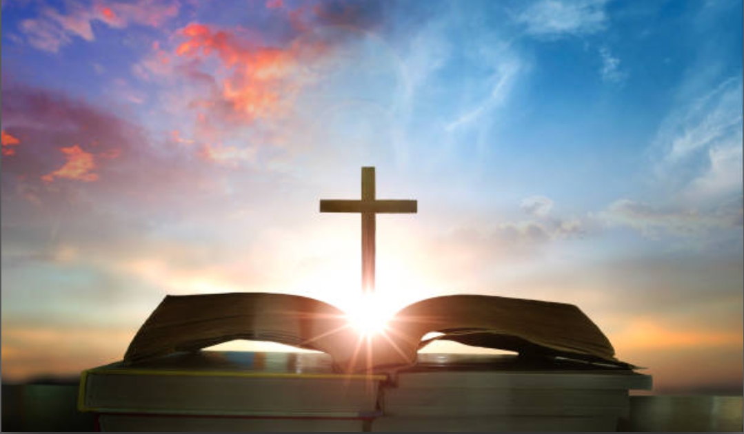 Christian daily devotion concept bible open with cross and morning light